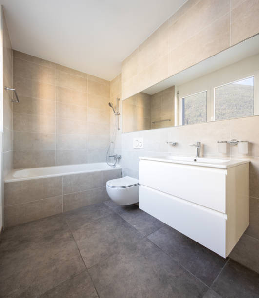 istock Modern minimal bathroom with large tile bathtub 1181207436