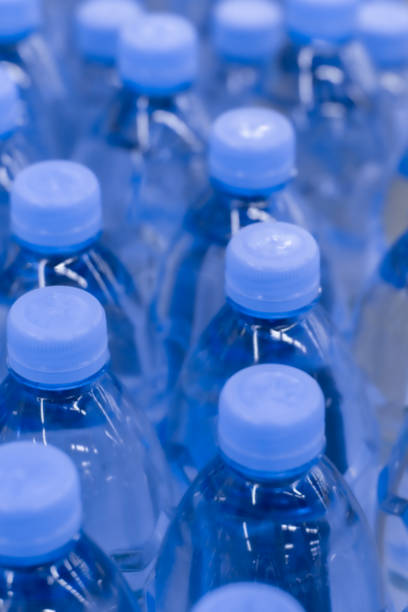 istock Defocus background, pure drinking water in plastic bottles. Many drinks bottles in a supermarket 1181207534