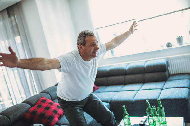 istock An older man cheers for his team 1181208007