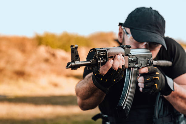 istock Close-up image of a man shooting a rifle, copy space. 1181208059