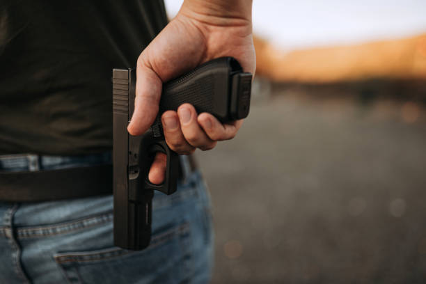 istock Man with a gun, close-up, copy space. 1181208100