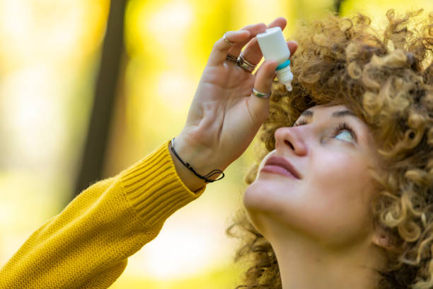 istock Young woman putting eye drops 1181209041