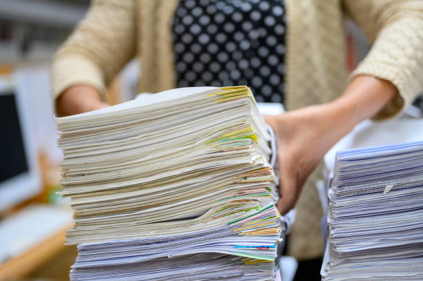 istock Working women holding documents at the office 1181209154