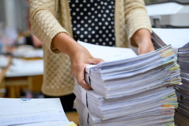 istock Working women holding documents at the office 1181209184