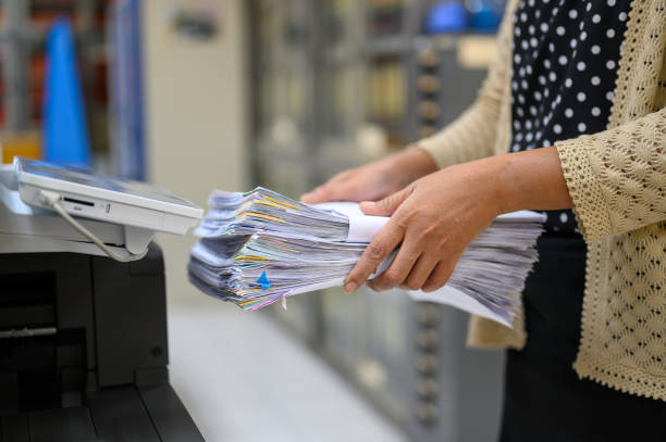 istock Working women holding documents at the office 1181209197