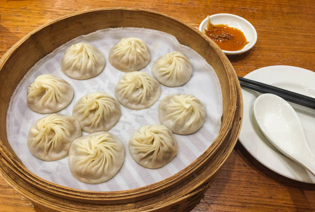 istock Xiao Long Bao or Chinese Soup Dumpling with minced pork inside in a bamboo streamer 1181209691