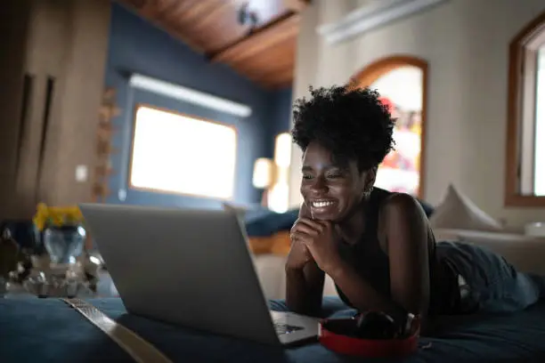 Photo of Young women watching movie on a laptop at home