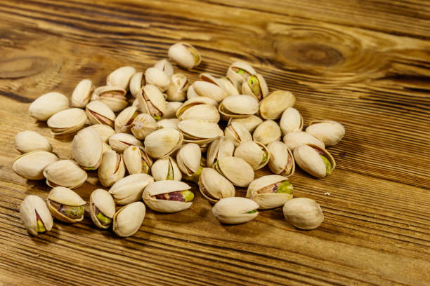 istock Pistachio nuts on a wooden table 1181210557