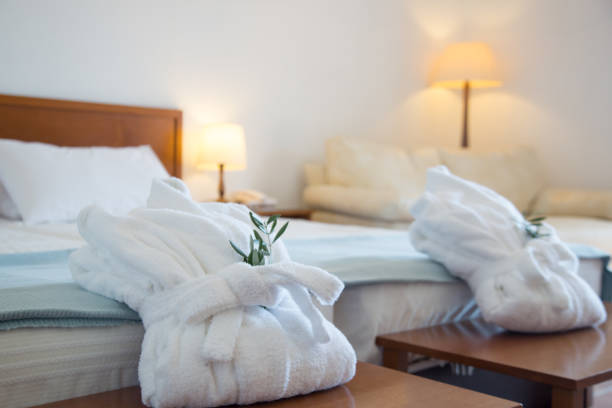 istock Two folded bathrobes on bed in room 1181214842