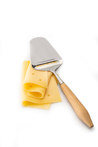 Cheese with a cheese-slicer , isolated on a white background