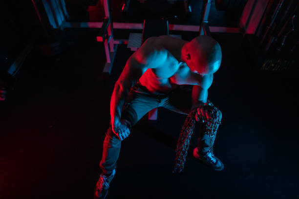 istock Body builder exercising with chains in gym 1181216488