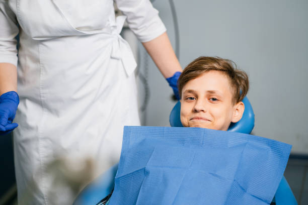 istock Dentist at work with little young cheerful patient 1181217833