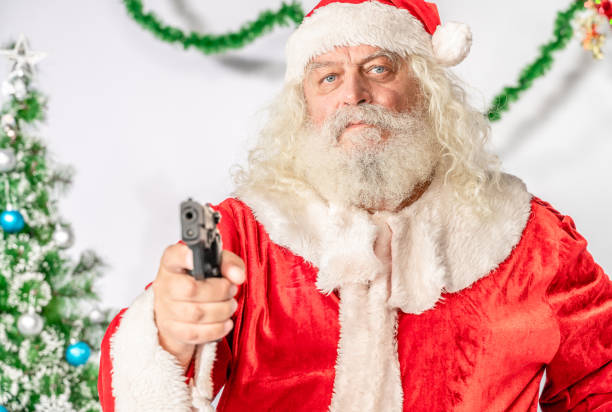 jultomten pekande pistol på kamera - santa hat bildbanksfoton och bilder