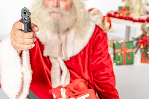 istock Black gun pointed at camera by Santa Claus 1181219504
