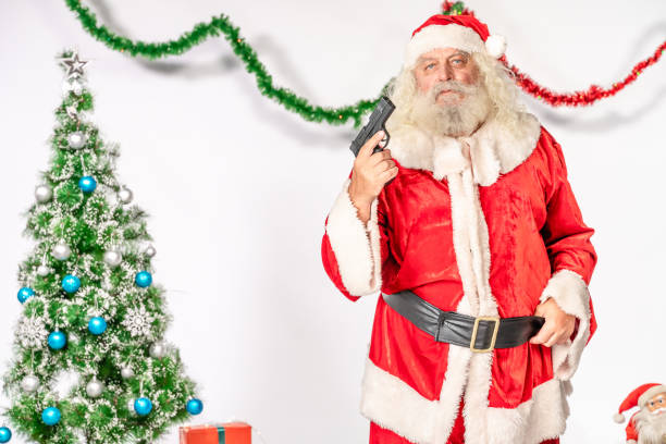 istock Santa Claus looking at camera with gun in his hand 1181219658