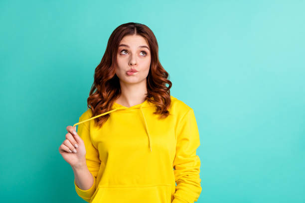 istock Photo of pensive creative trendy thinking youngster recollecting exam schedule while biting lips looking up in brainstorming isolated over turquoise vivid color background 1181220002