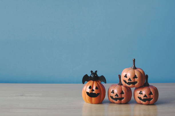 istock Pumpkins on wood table. Halloween holiday background. 1181220739