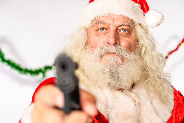istock Santa Claus with semi-automatic pistol close-up 1181220933