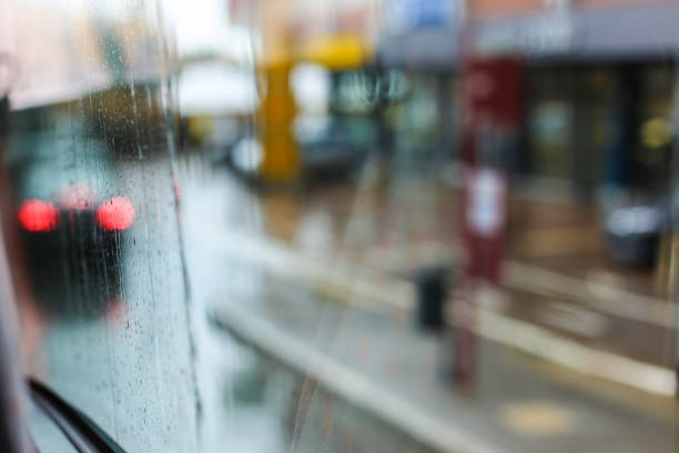 istock Rainy glass and street lights in background 1181221026