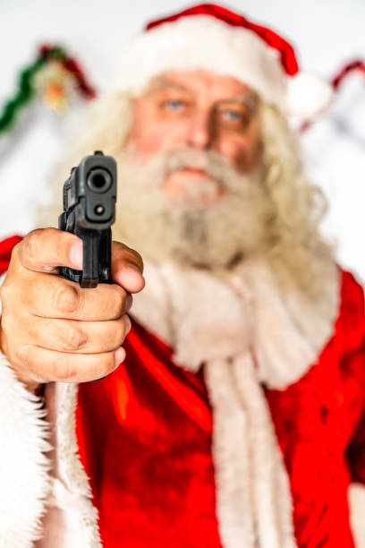 istock Bad Santa Claus with semi-automatic pistol 1181221050