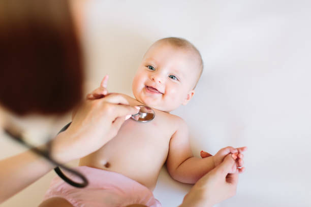 istock Baby at the doctor getting breath check up with stethoscope 1181221180