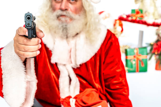 istock Angry Santa Claus pointing a gun at camera 1181221227
