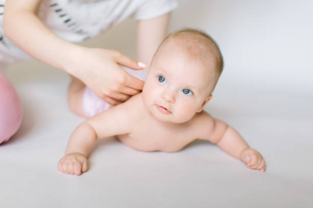 istock Mother massaging and exercise her little baby back 1181221396