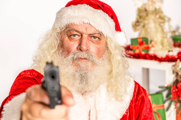 istock Displeased Santa Claus with gun 1181222078