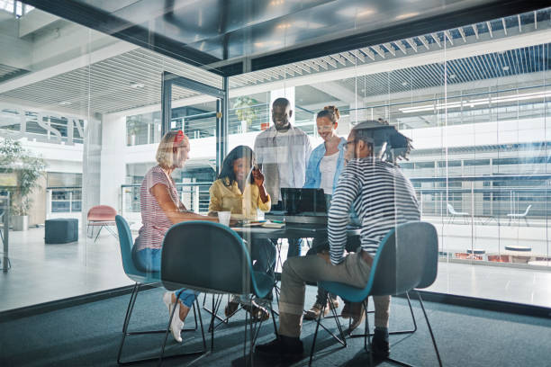istock Diverse businesspeople working around a table in an office boardroom 1181222947