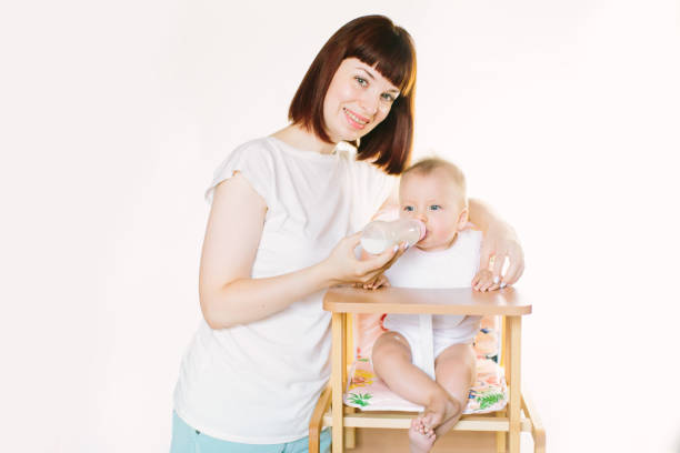 istock A young beautiful mother feeds a baby from a bottle 1181223107