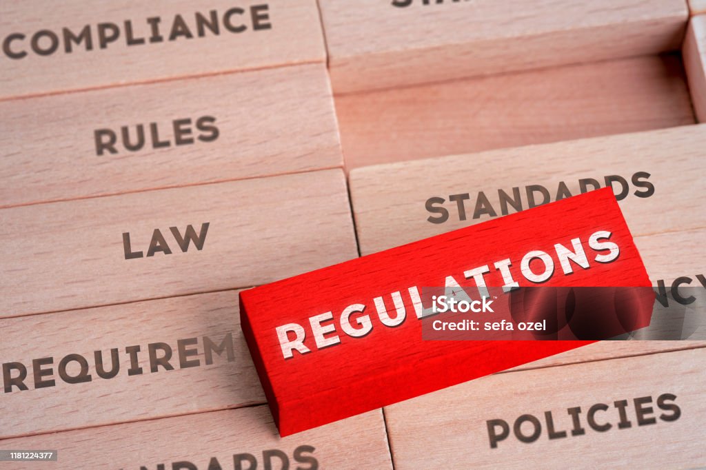 Regulations Concept with Wooden Blocks in Red Color Law, Rules, Standards, Agreement, Contract Law Stock Photo