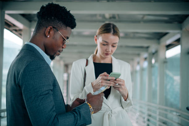 istock Two Business Person Looking at Mobile Phone 1181224455