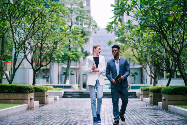 istock Businesspeople Having Conversation, While on The Way to a Meeting 1181224706
