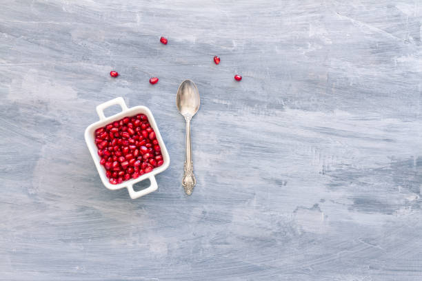istock Pomegranate Seeds in a white bowl. Top view or overhead view composition with copy space 1181224724