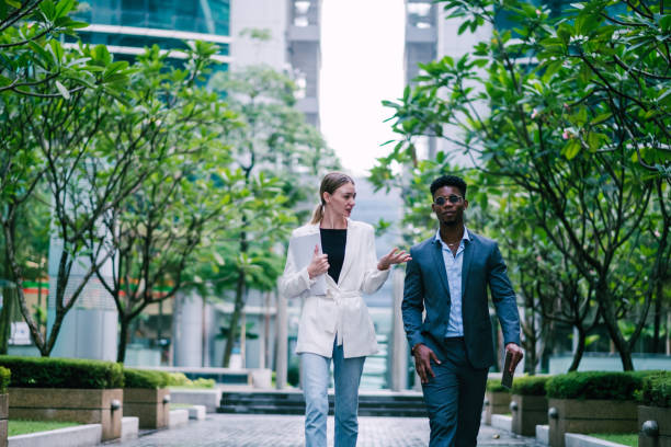 istock Businesspeople Having Conversation, While on The Way to a Meeting 1181224821