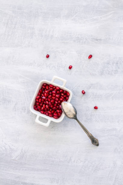 istock Pomegranate Seeds in a white bowl. Top view or overhead view composition with copy space 1181224851