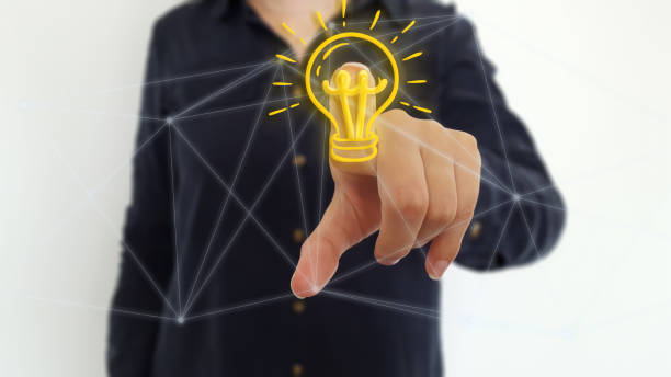 istock Businesswoman using light bulb on network hologram 1181224963