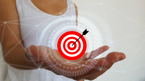istock Businesswoman holding target and arrow with digital interface 1181225612