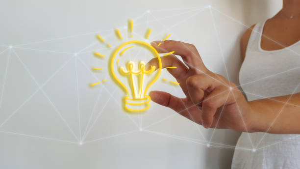 istock Businesswoman touching digital light bulb 1181225757