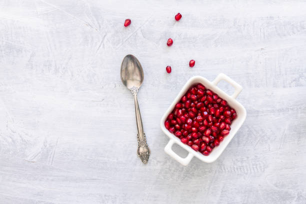 istock Pomegranate Seeds in a white bowl. Top view or overhead view composition with copy space 1181225776