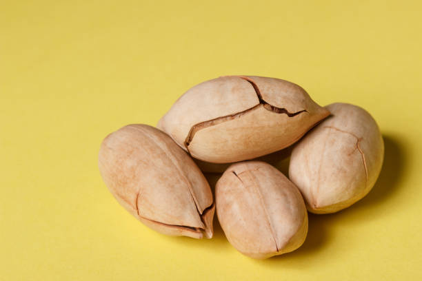 istock Background: pecan on a yellow background 1181226602