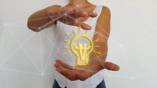 istock Bussinesswoman holding in hands light bulb 1181227684