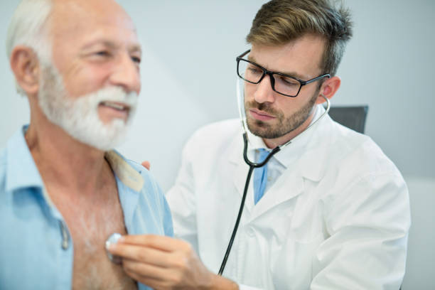 istock Doctor examining senior man's heart with stethoscope. 1181227827