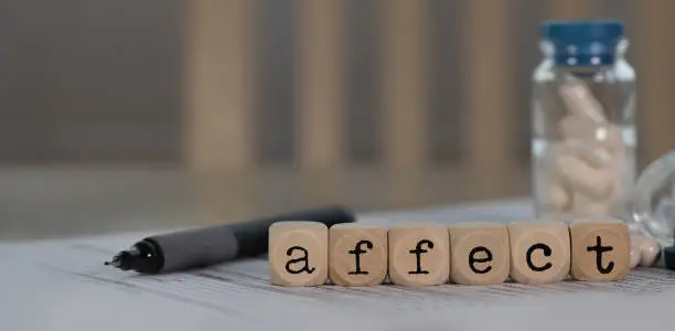 Photo of Word AFFECT composed of wooden dices.