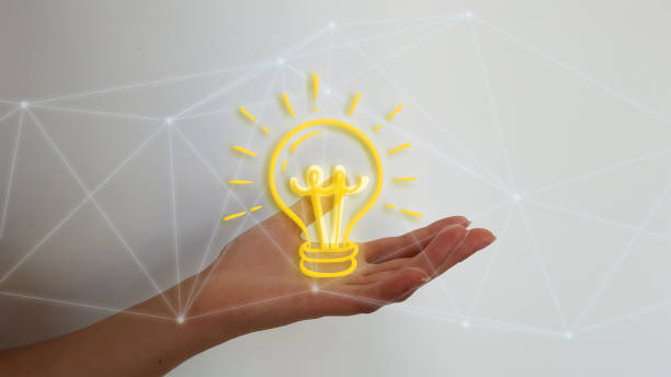 istock Woman hand on blurred background holding digital light bulb 1181230970