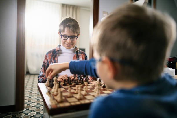 istock Two boys playing chess on chair 1181232635