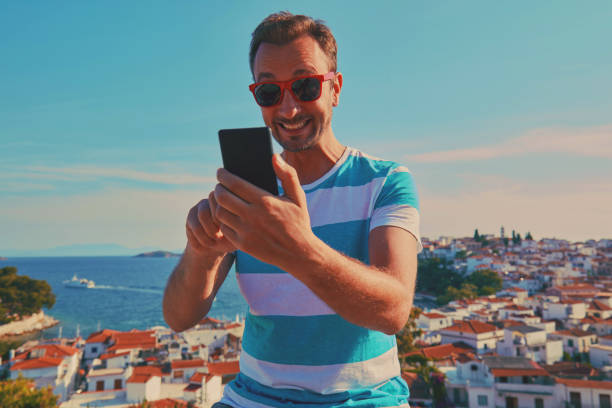 istock Attractive man using cellphone outdoors. 1181233186