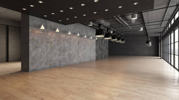 istock Large open empty space with concrete wall illuminated by natural light from windows 1181233259