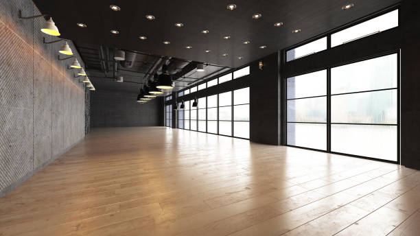 istock Large open empty space with concrete wall illuminated by natural light from windows 1181233261