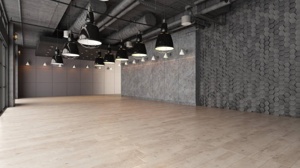 istock Large open empty space with concrete wall illuminated by natural light from windows 1181233265